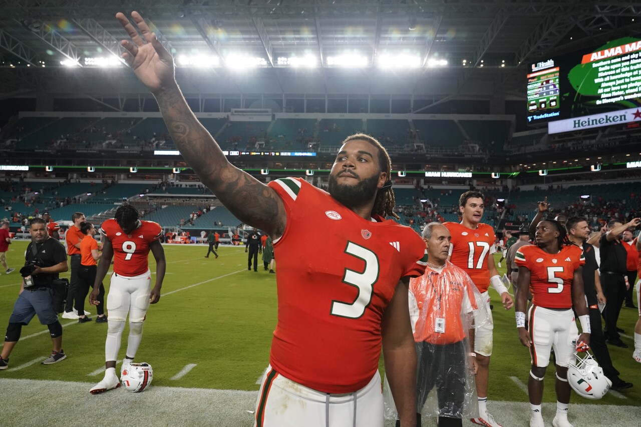 Miami Hurricanes defensive lineman Akheem Mesidor celebrates with fans after beating Miami RedHawks at Hard Rock Stadium, Sept. 1, 2023