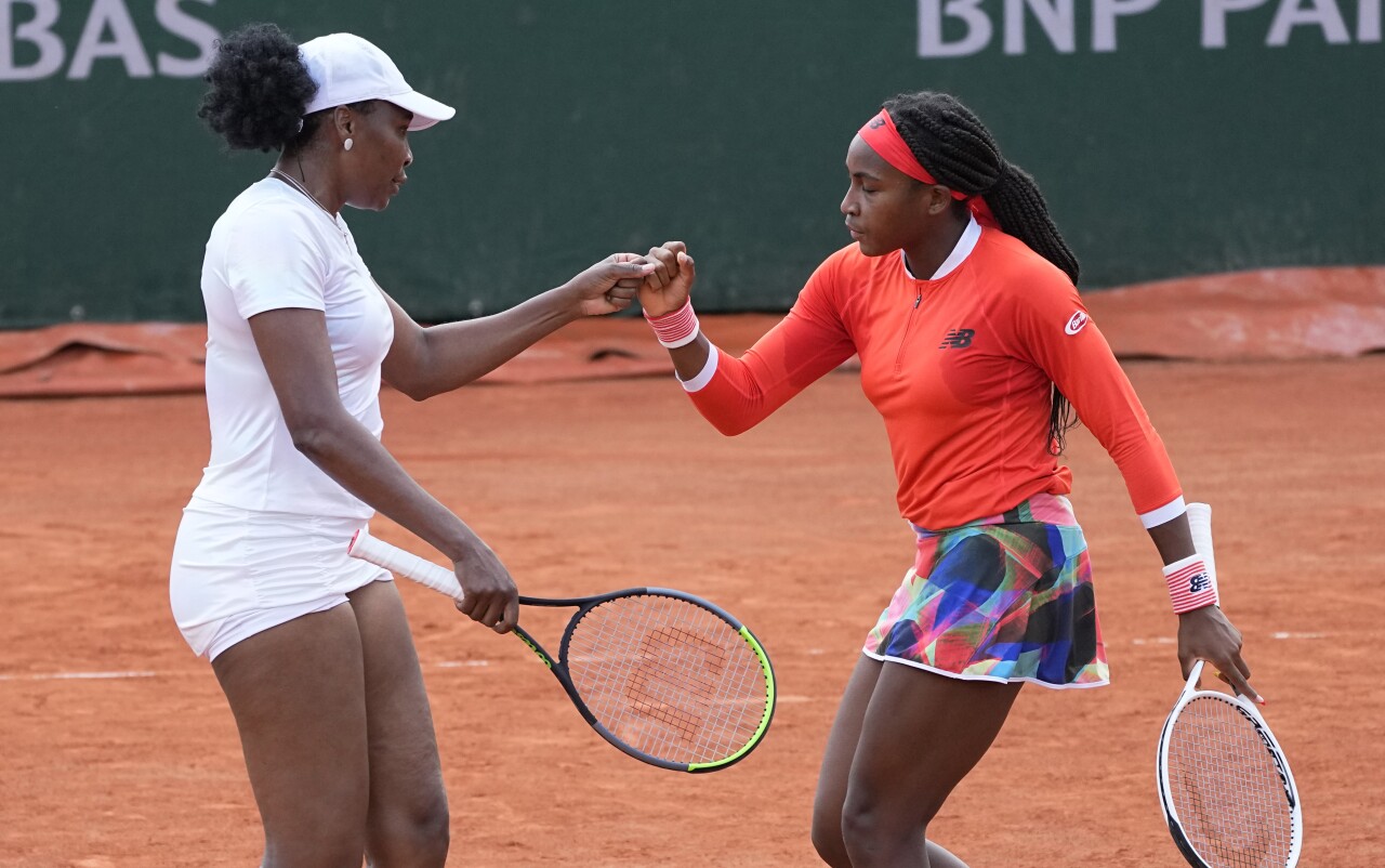 Venus Williams and Coco Gauff bump fists during French Open doubles appearance, June 2, 2021