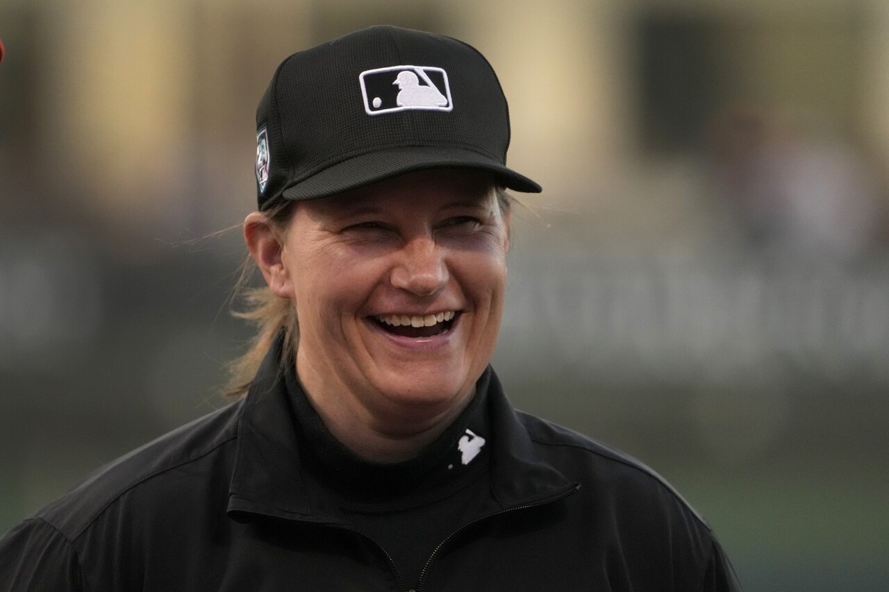 Umpire Jen Pawol smiles during lineup card exchange before spring training game between Washington Nationals and Houston Astros, Feb. 24, 2024