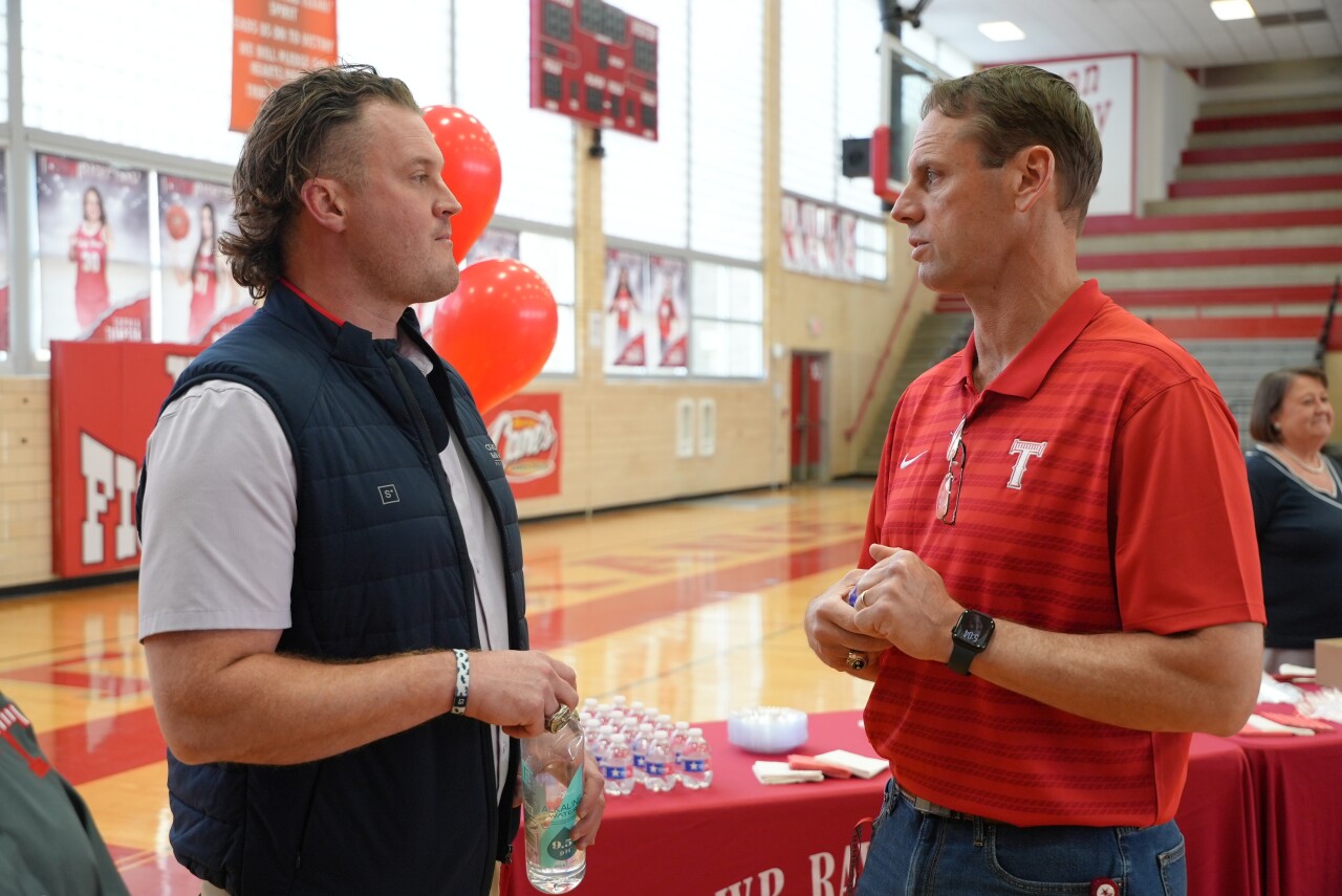 Ray 2005 alum Clint Gresham with new football head coach Brian Herman