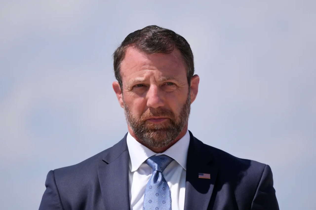 Homeland Security Secretary Markwayne Mullin, listens as President Donald Trump speaks to the press after returning and stepping off Air Force, Wednesday, May 20, 2026, at Joint Base Andrews, Md.