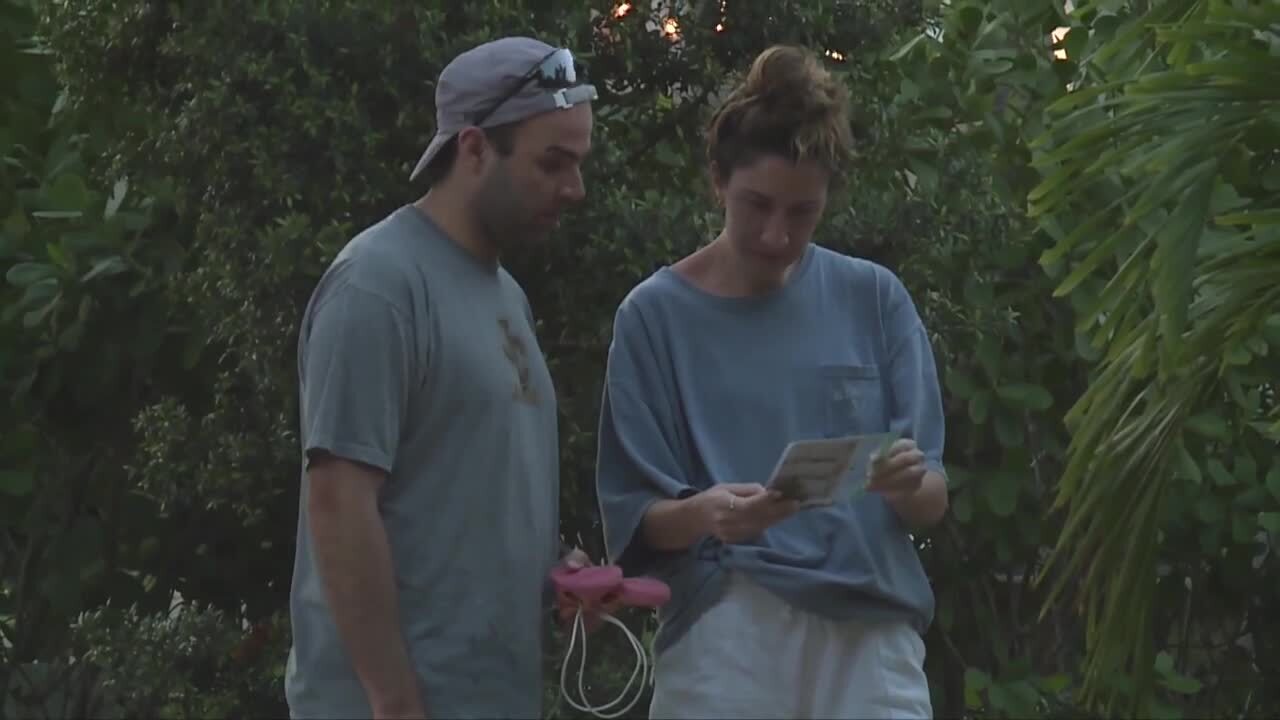 Couple looks at antisemitic flyer left outside their West Palm Beach home, March 11, 2023