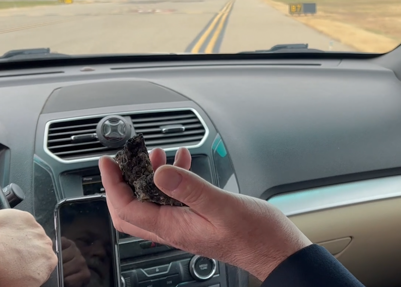 pieces of asphalt scattered along the runway