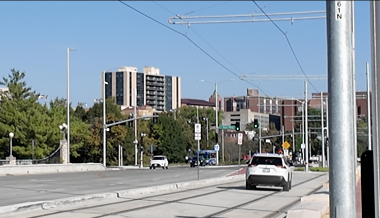 SUV driving on Streetcar tracks and through Plaza Transit Center.png