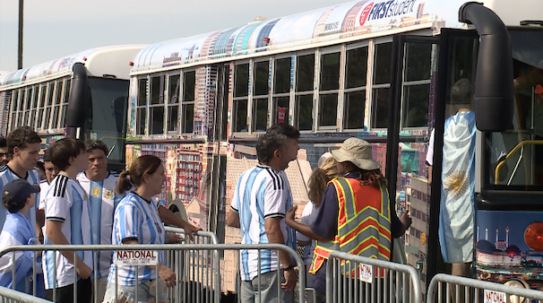 people lining up to get on bus.png