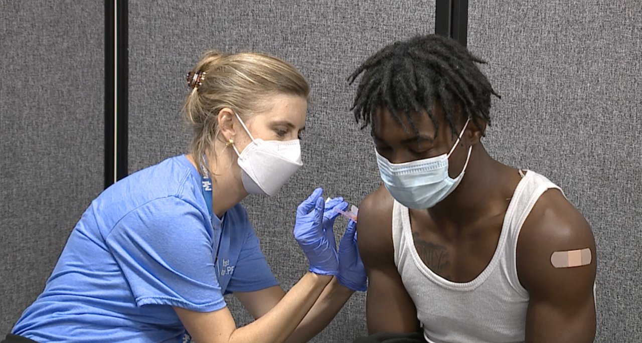 Student receives vaccine at Heights High School health clinic from MetroHealth Hospitals nurse