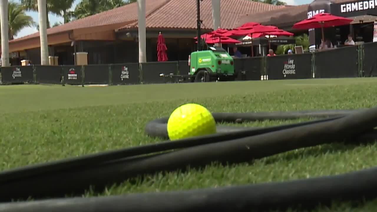 yellow golf ball on grass at 2021 Honda Classic