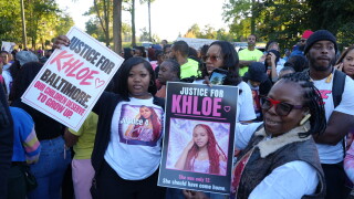 Friends and family holding up Justice for Khloe signs