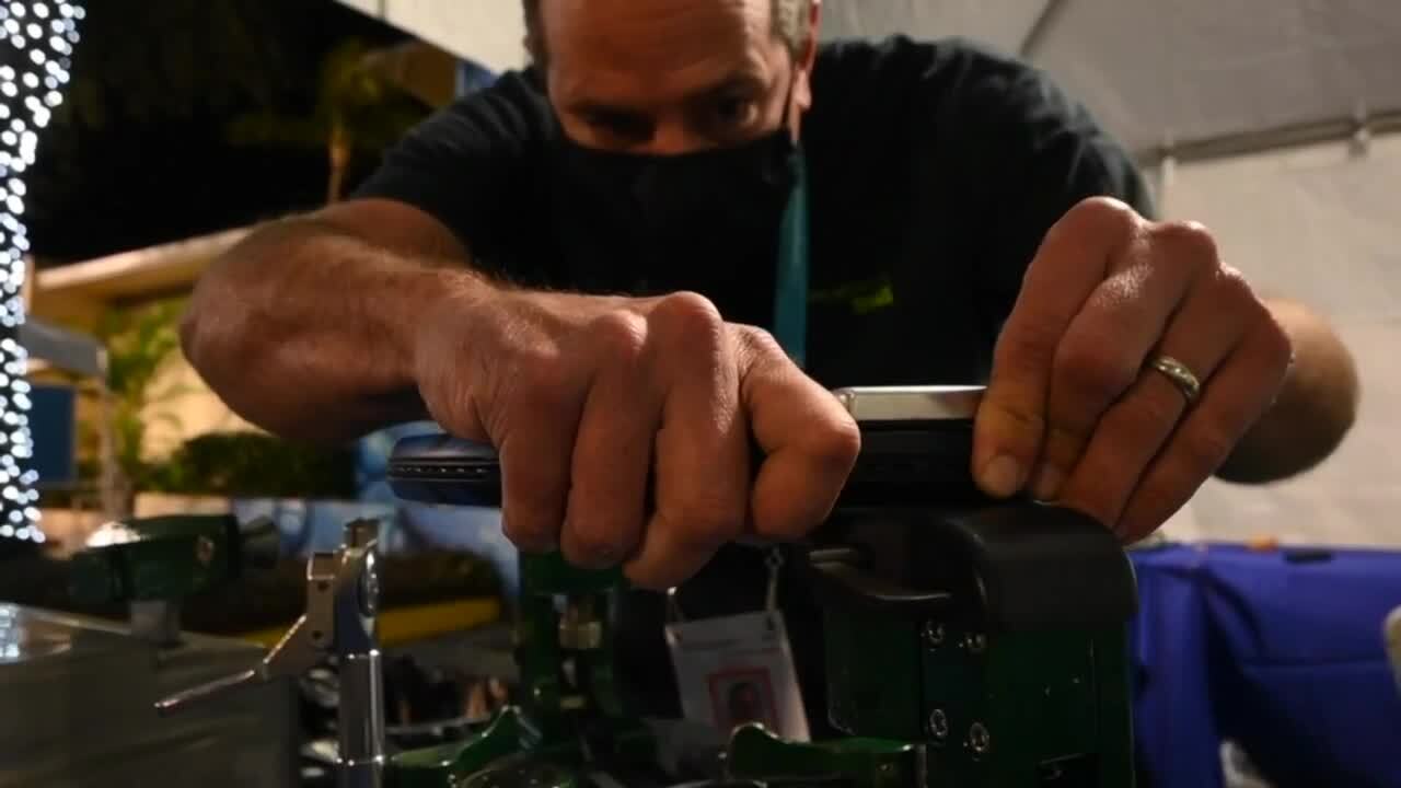 Jay Lewandowski, stringing tennis racquet at Delray Beach Open
