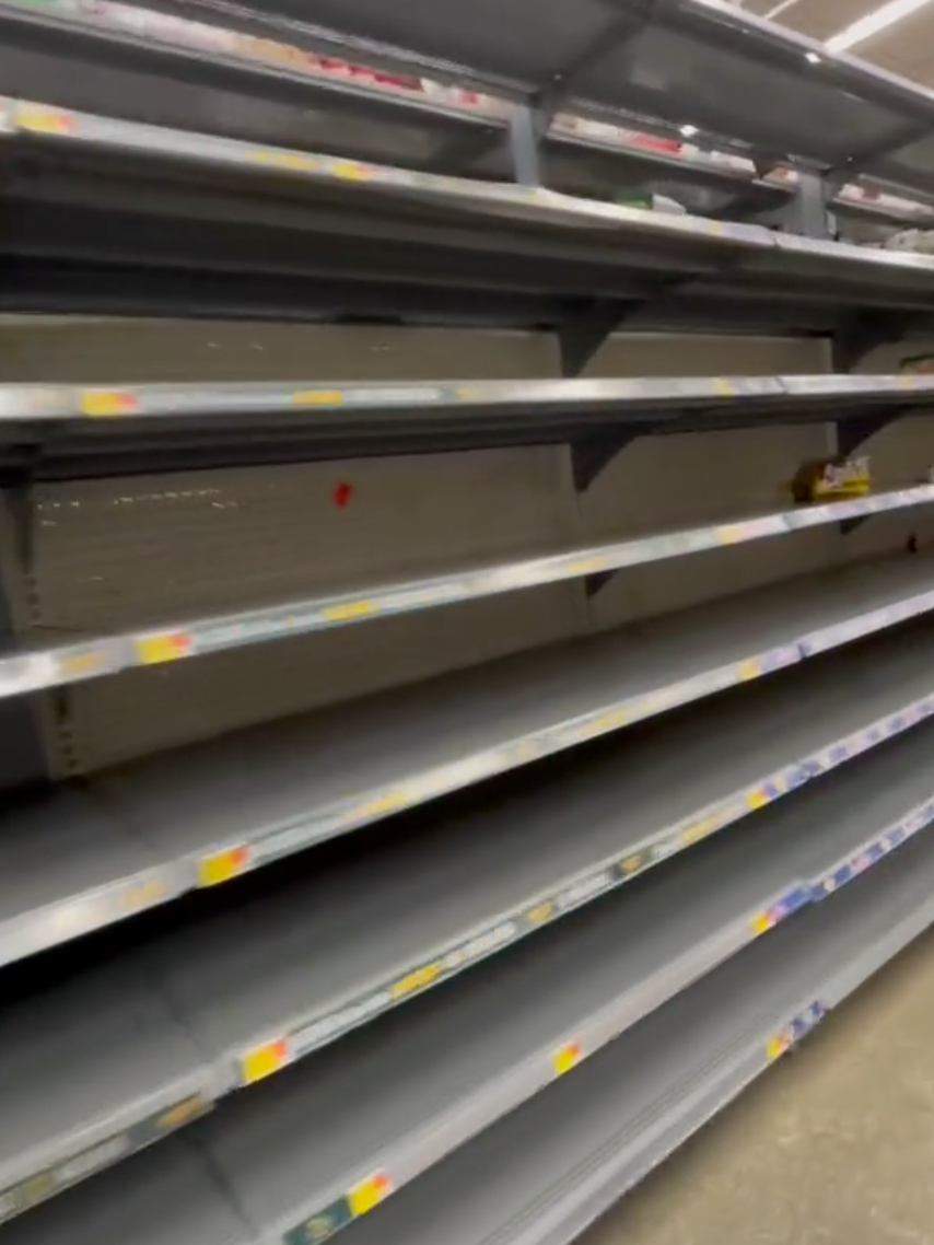 Nearly empty grocery shelf.