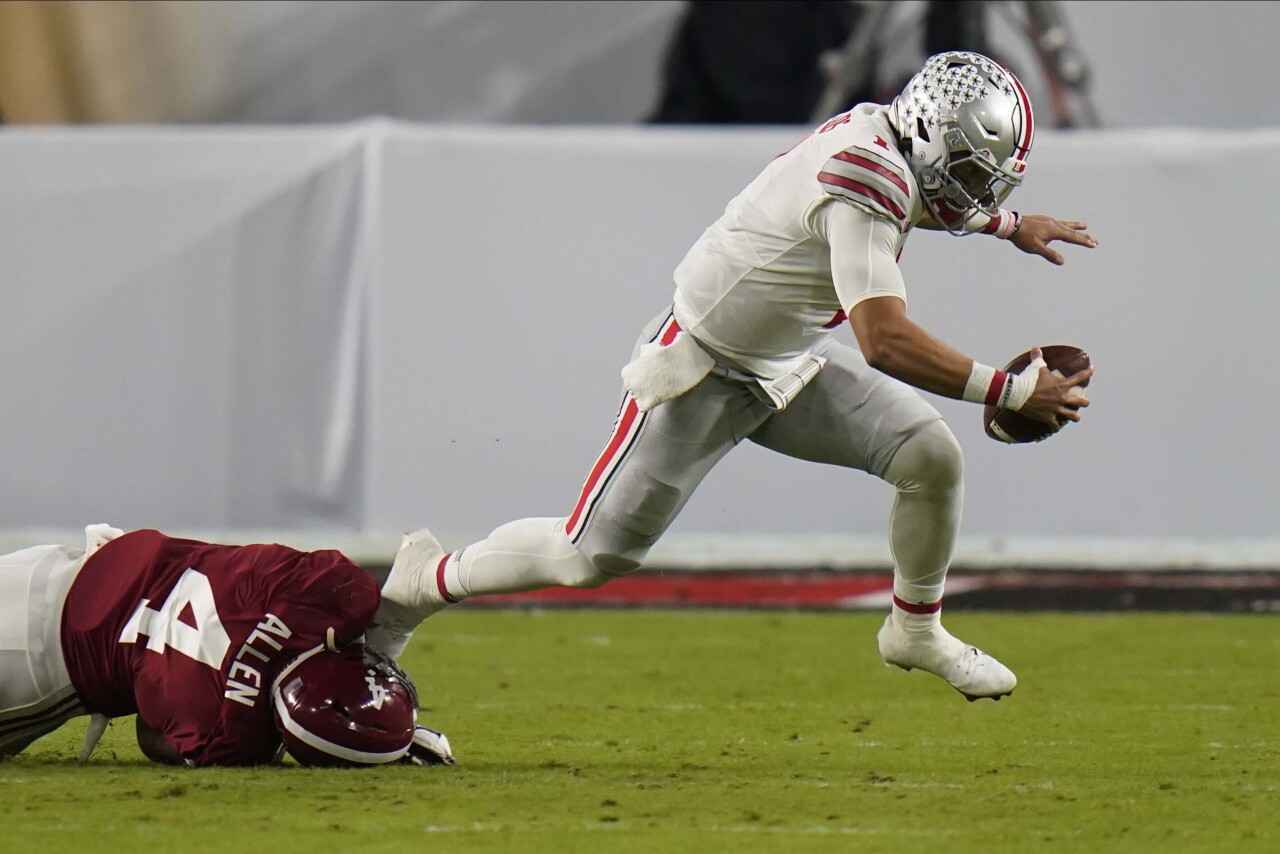Ohio State Buckeyes QB Justin Fields tackled by Alabama Crimson Tide linebacker Christopher Allen in first quarter of 2021 College Football Playoff National Championship