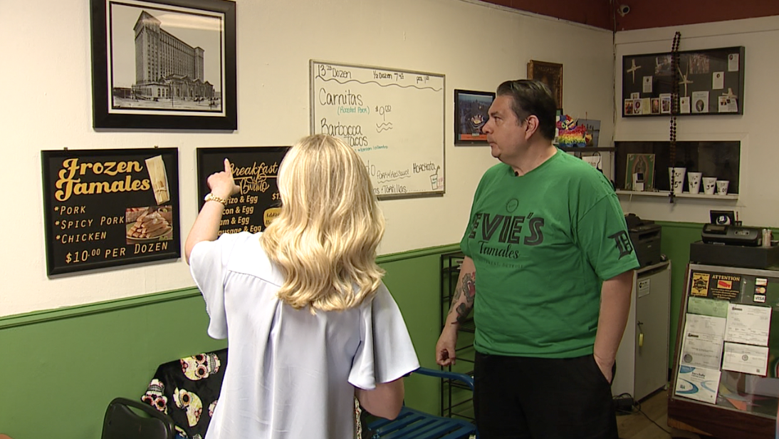 Eugene Cooley showing his 1913 photograph of Michigan Central Station on the walls of his restaurant, Evie’s Tamales. (June 3, 2024)