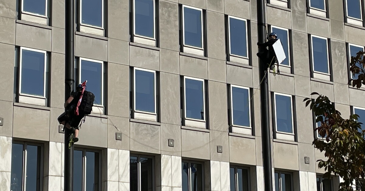 2 arrested after protesters climb flagpoles and demand action outside Procter & Gamble headquarters