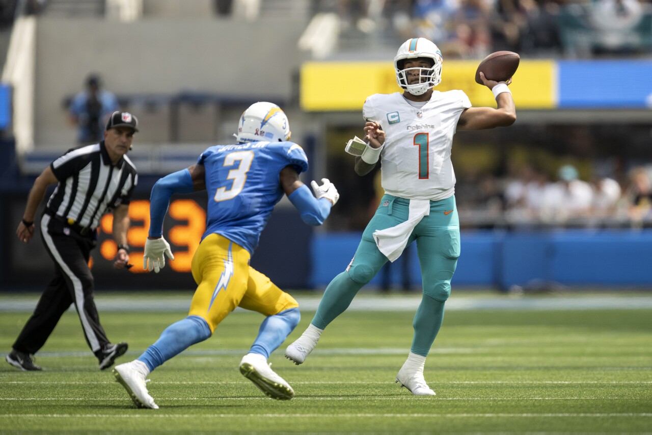 Miami Dolphins QB Tua Tagovailoa throws as Los Angeles Chargers safety Derwin James approaches, Sept. 10, 2023