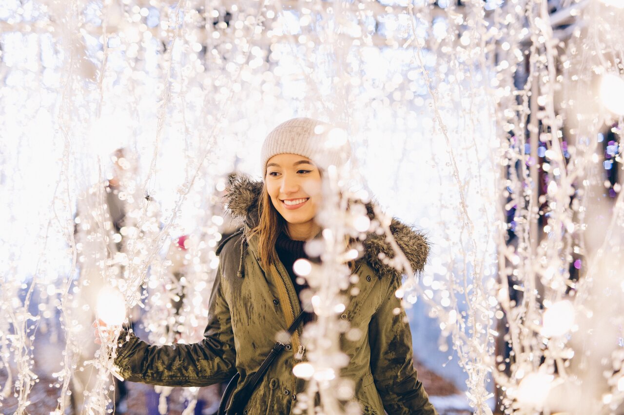 Enchant-Christmas-Young-Woman-Dangling-Lights.jpg
