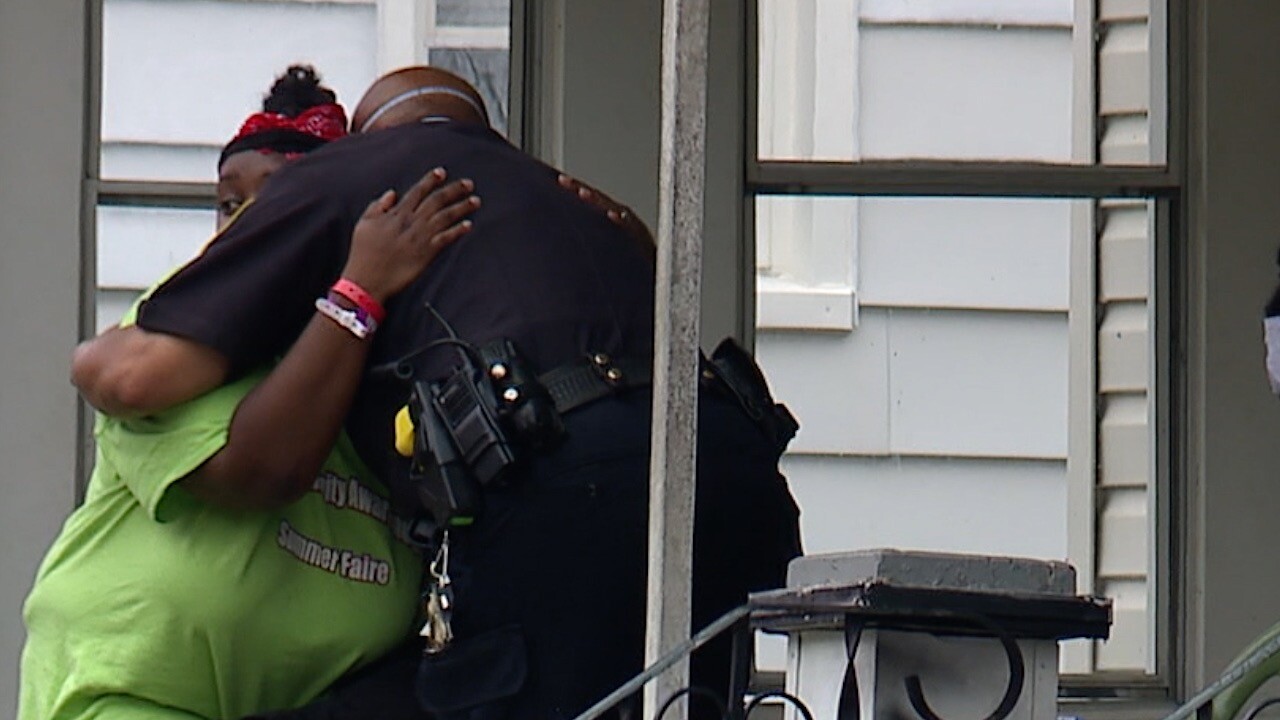 Akron Police officer hugs Mother of Ty'leia Junius (1).jpg