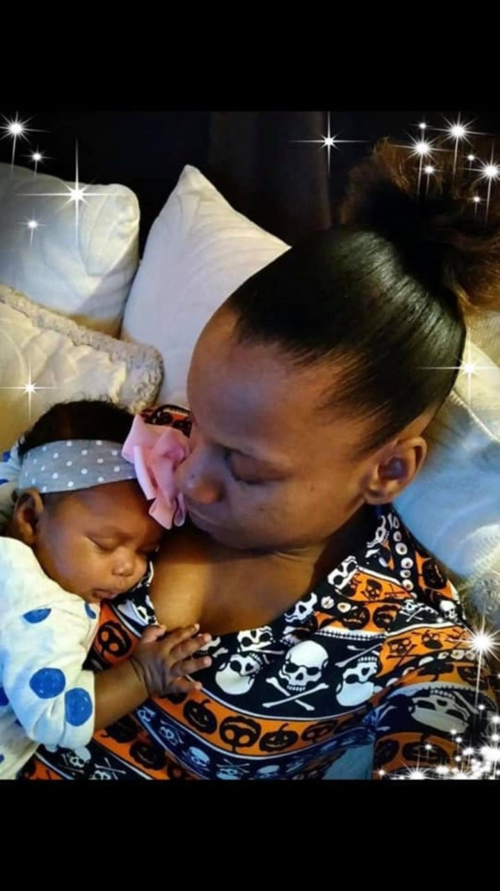 Natalya Nicholson holding infant