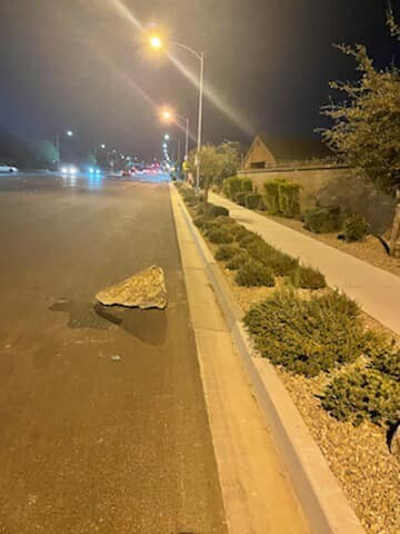 BOULDER THROWN AT CAR