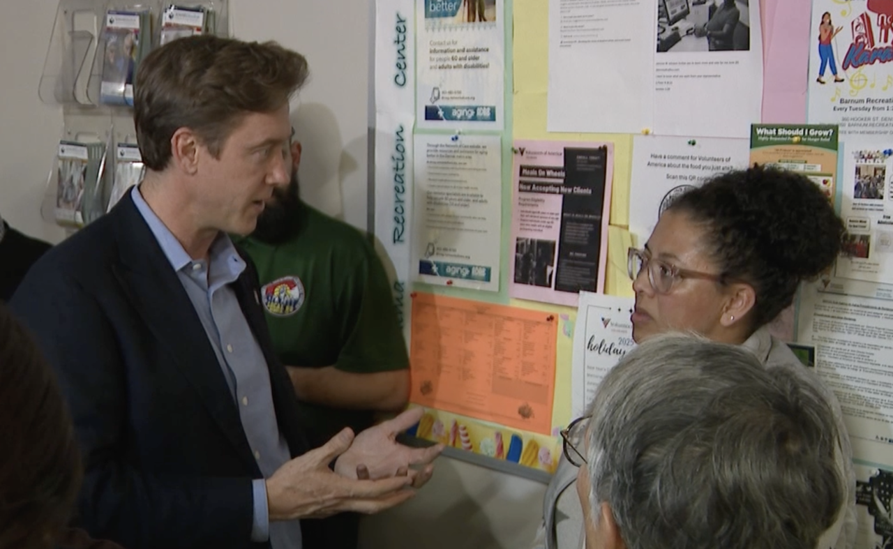 Denver Mayor Mike Johnston speaks with Misty Lubin-Salazar after she expressed concerns about the Burnham Yard project's impact to the surrounding neighborhoods.