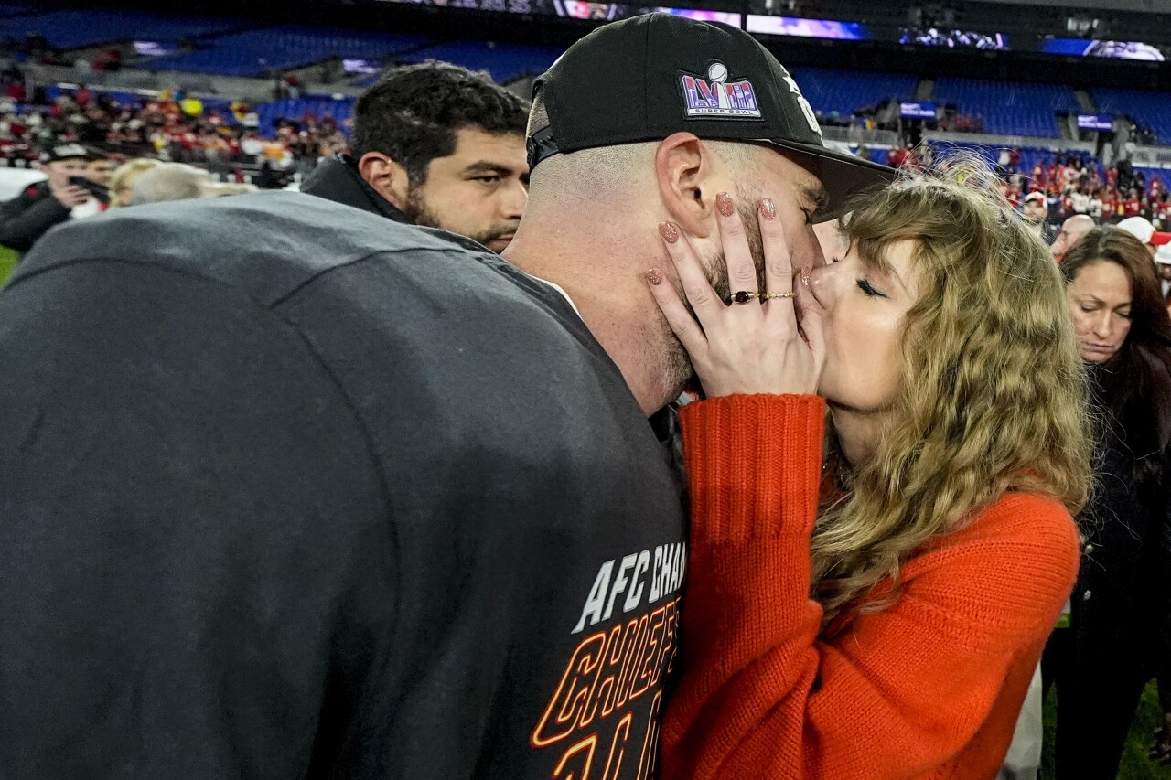 Taylor Swift kisses Kansas City Chiefs tight end Travis Kelce after AFC Championship, Jan. 28, 2024