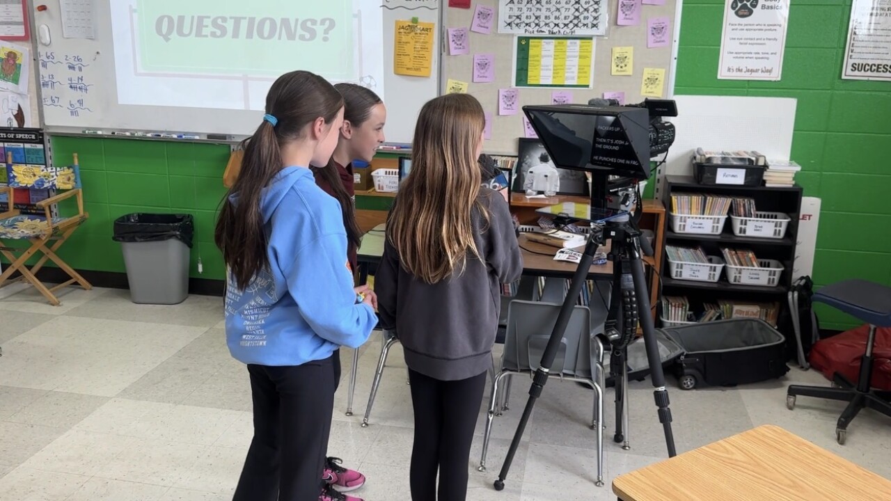 Students read on the teleprompter