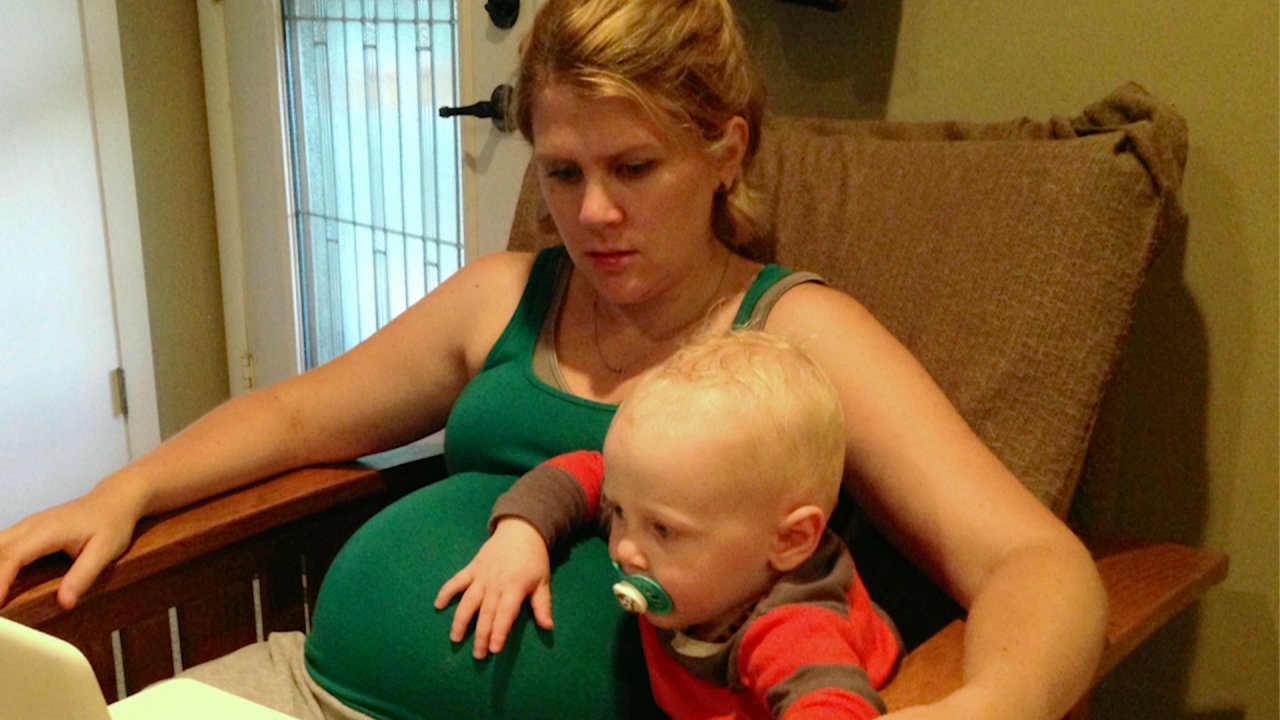 Amanda Duffy pregnant and holding her son