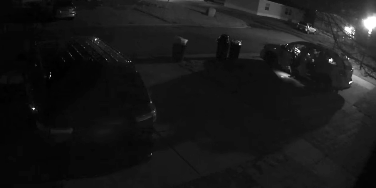 Suspects are looking through a car