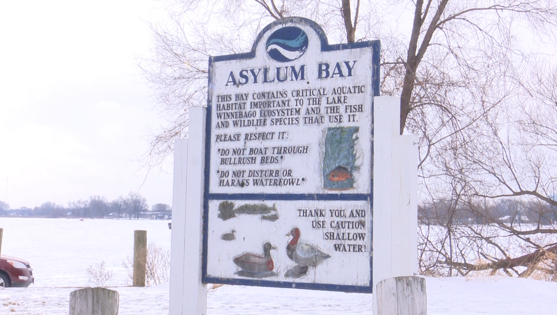 Father and son hit the ice and take advantage of free fishing weekend in Wisconsin