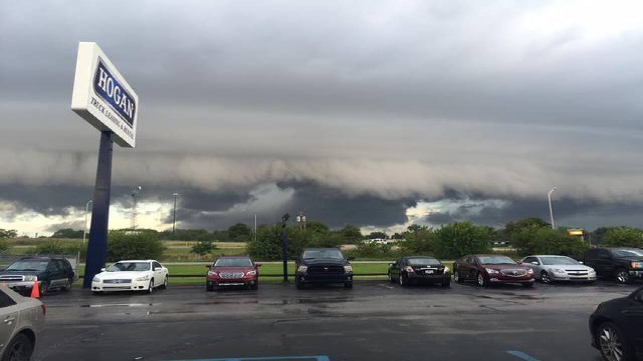 PHOTOS: Ominous clouds, downed trees, flooding