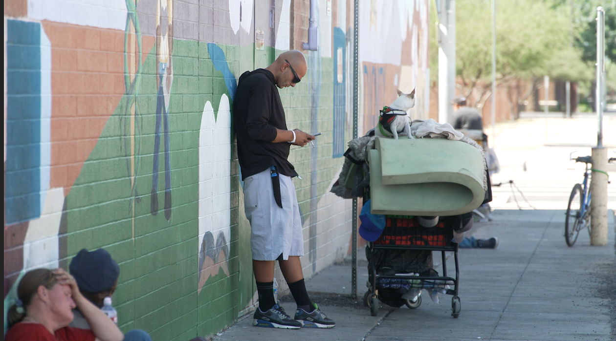 People rest in the shade amid triple-digit temperatures in Phoenix, Arizona.