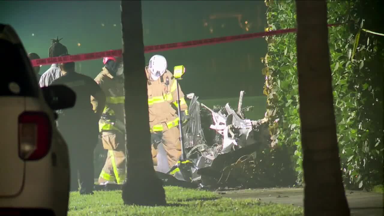 authorities inspect wreckage of fiery crash on Flagler Drive on New Year's Day 2023