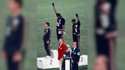 Athletes do the black power salute.