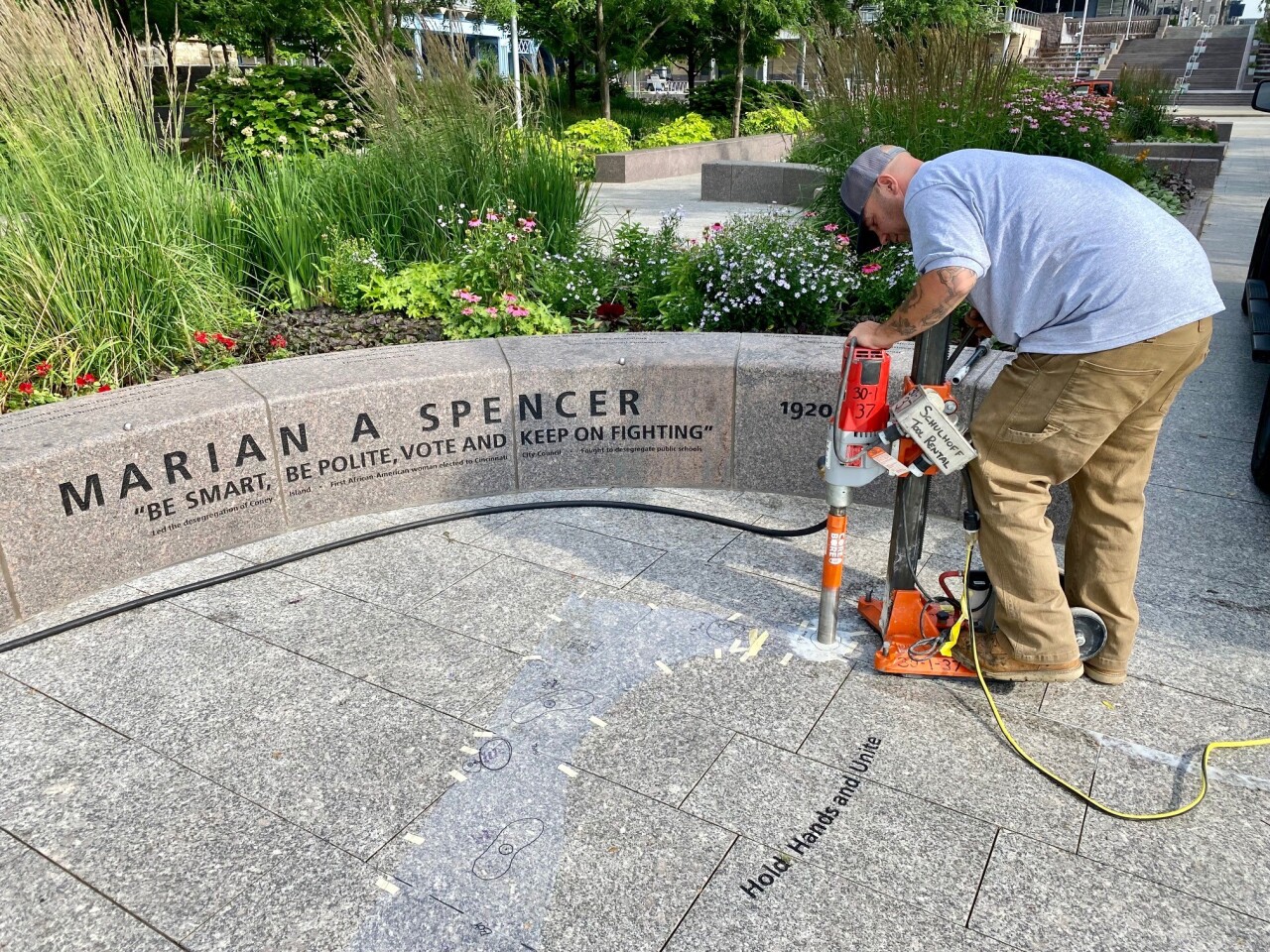 A worker prepares the area in Cincinnati's Smale Riverfront Park where a life-sized sculpture of Marian Spencer will be dedicated on June 27, 2021.
