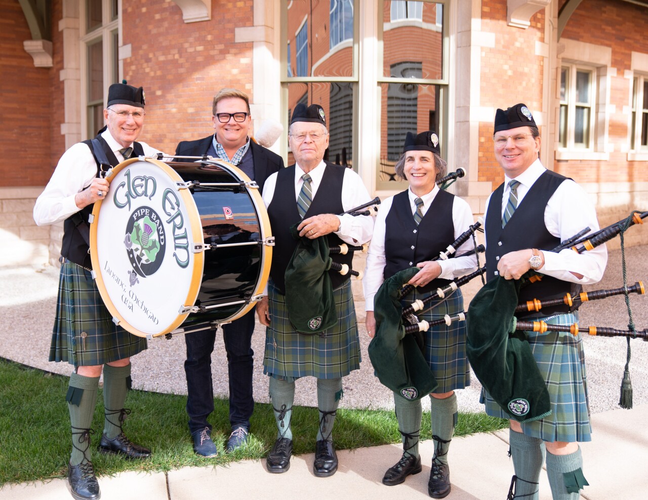 Bob Hoffman poses with the members of The Glen Erin Pipe Band.