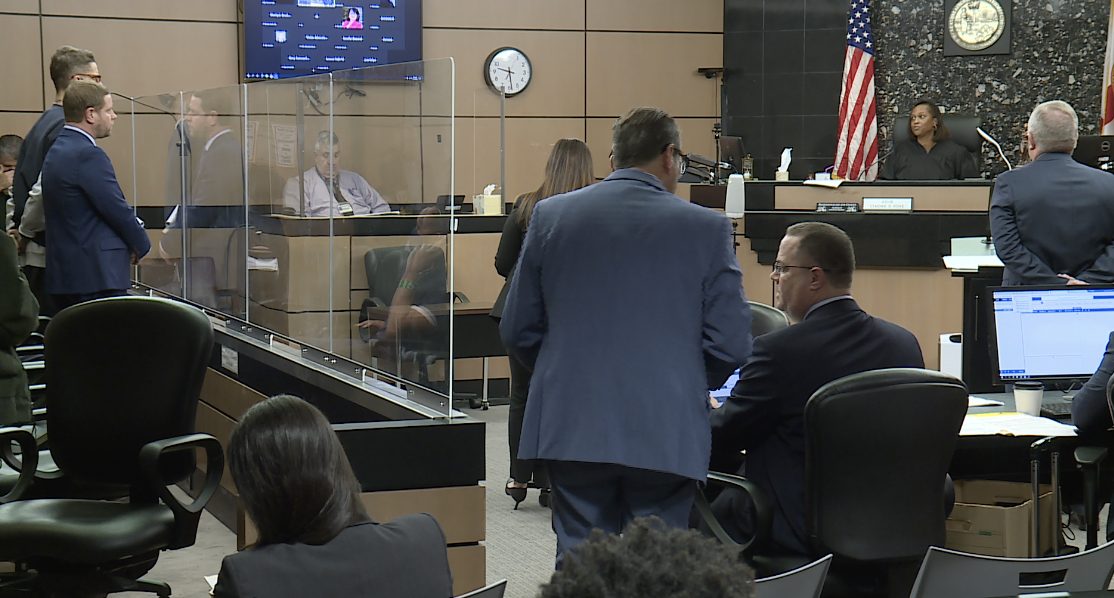 Michael Hutto in court with lawyers and judge as he enters guilty plea, Feb. 16, 2023