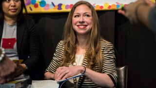 Chelsea Clinton signs a book.