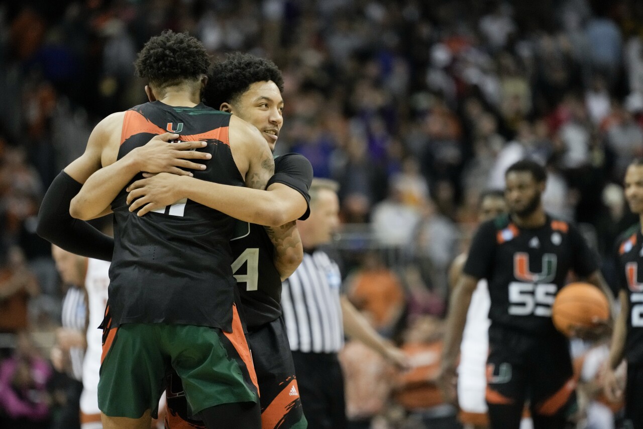 Miami Hurricanes guards Nijel Pack and Jordan Miller embrace after winning Elite Eight game of NCAA tournament, March 26, 2023