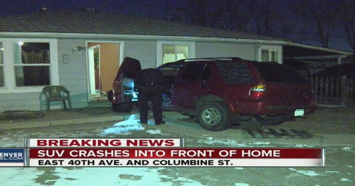 SUV crashes through fence & into home