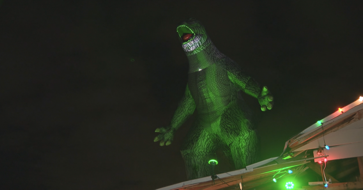 Godzilla Cheering Lakeland Godzilla house spreads holiday cheer despite hurricane damage