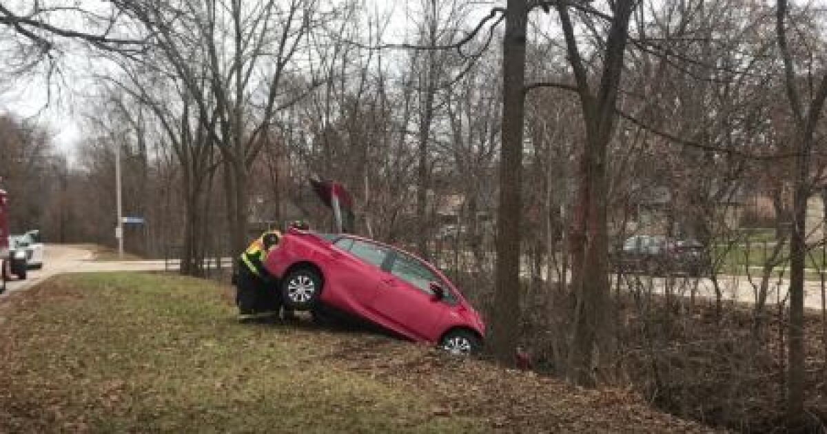 Car veers off road and dangles over water