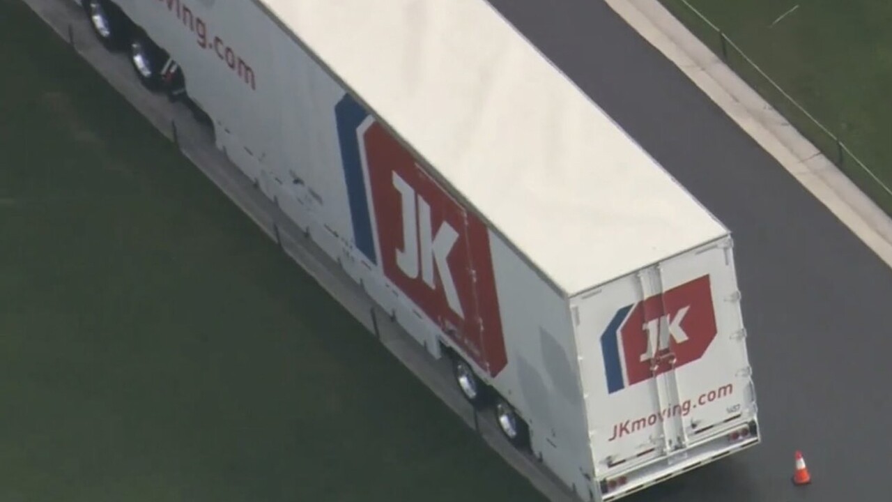 Moving trucks from JK Moving Services arrive at President Donald Trump's Mar-a-Lago club on Jan. 18, 2021.jpg