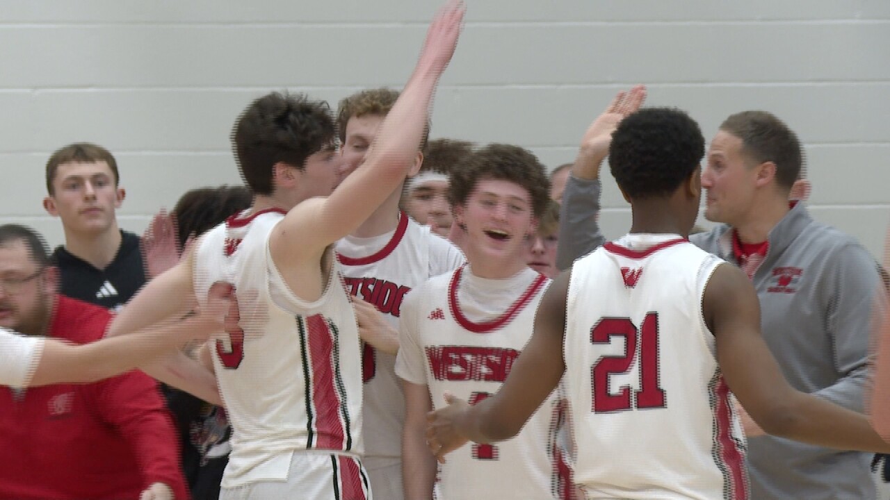 The Omaha Westside boys celebrate after regaining the lead at the end of the third quarter in the Metro Holiday Tournament final