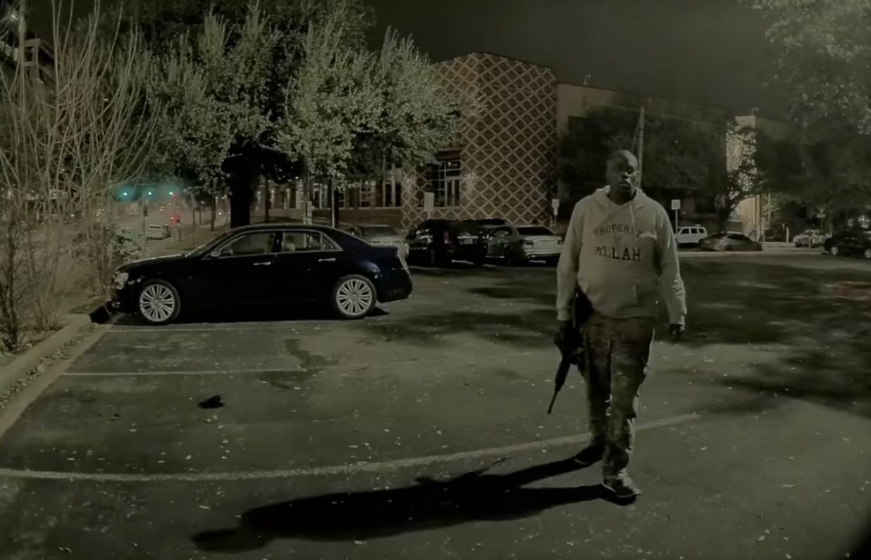 Video from a parked car recorded the shooter holding his rifle, then raising it and firing at someone passing by.