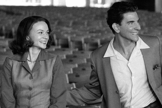 Carey Mulligan as Felicia Montealegre and Bradley Cooper as Leonard Bernstein in black-and-white scene from 'Maestro'