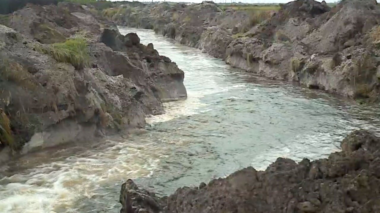 Water flowing into berm in effort to extinguish Port St. Lucie mulch fire, Sept. 14, 2022