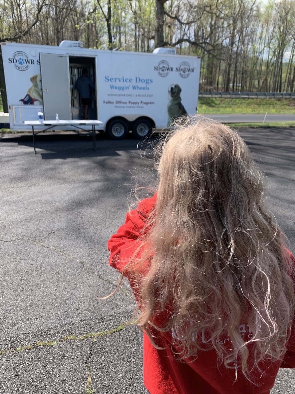 Sophie picking up Jacoby at trailer in winery parking lot in Madison, VA