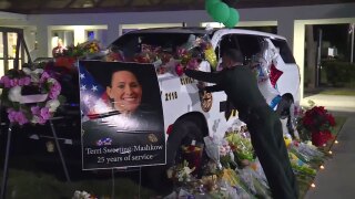 A growing memorial for Deputy Terri Sweeting-Mashkow stands outside the Indian River County Sheriff's Office.