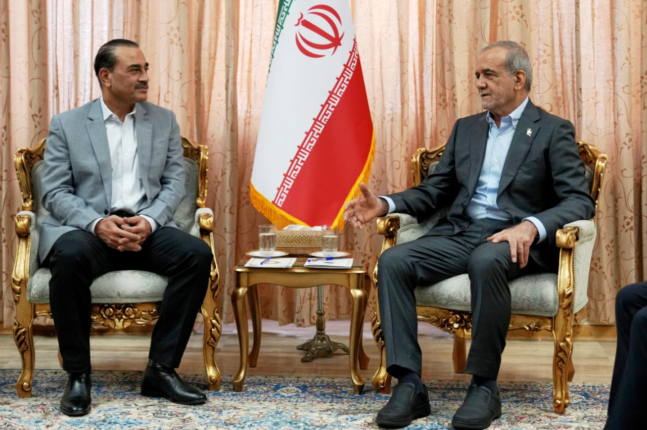 In this photo released by the Iranian Presidency Office, President Masoud Pezeshkian, right, speaks with Pakistan’s Army Chief Field Marshal Gen. Asim Munir in Tehran, Iran, Saturday, May 23, 2026.