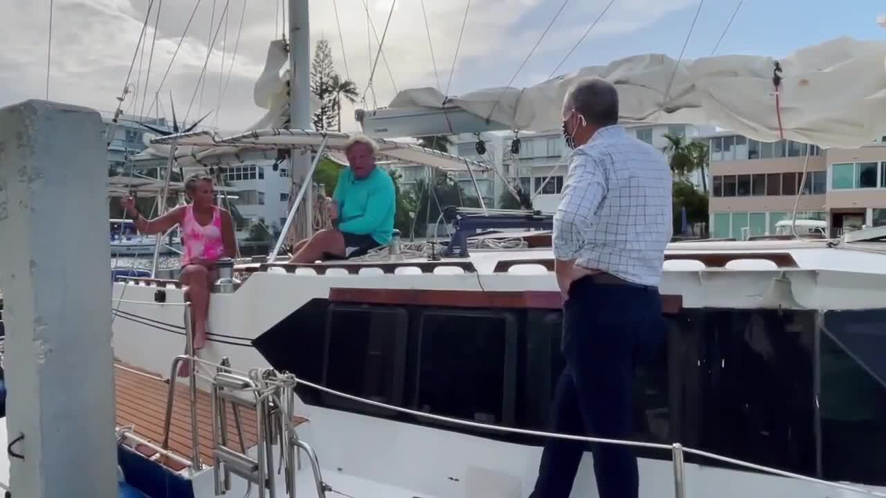 Michael Buczyner speaks to Marty Widrick and Sven Karrlson on their sailboat docked in Fort Lauderdale