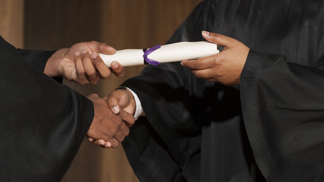 Diploma in hands at graduation ceremony
